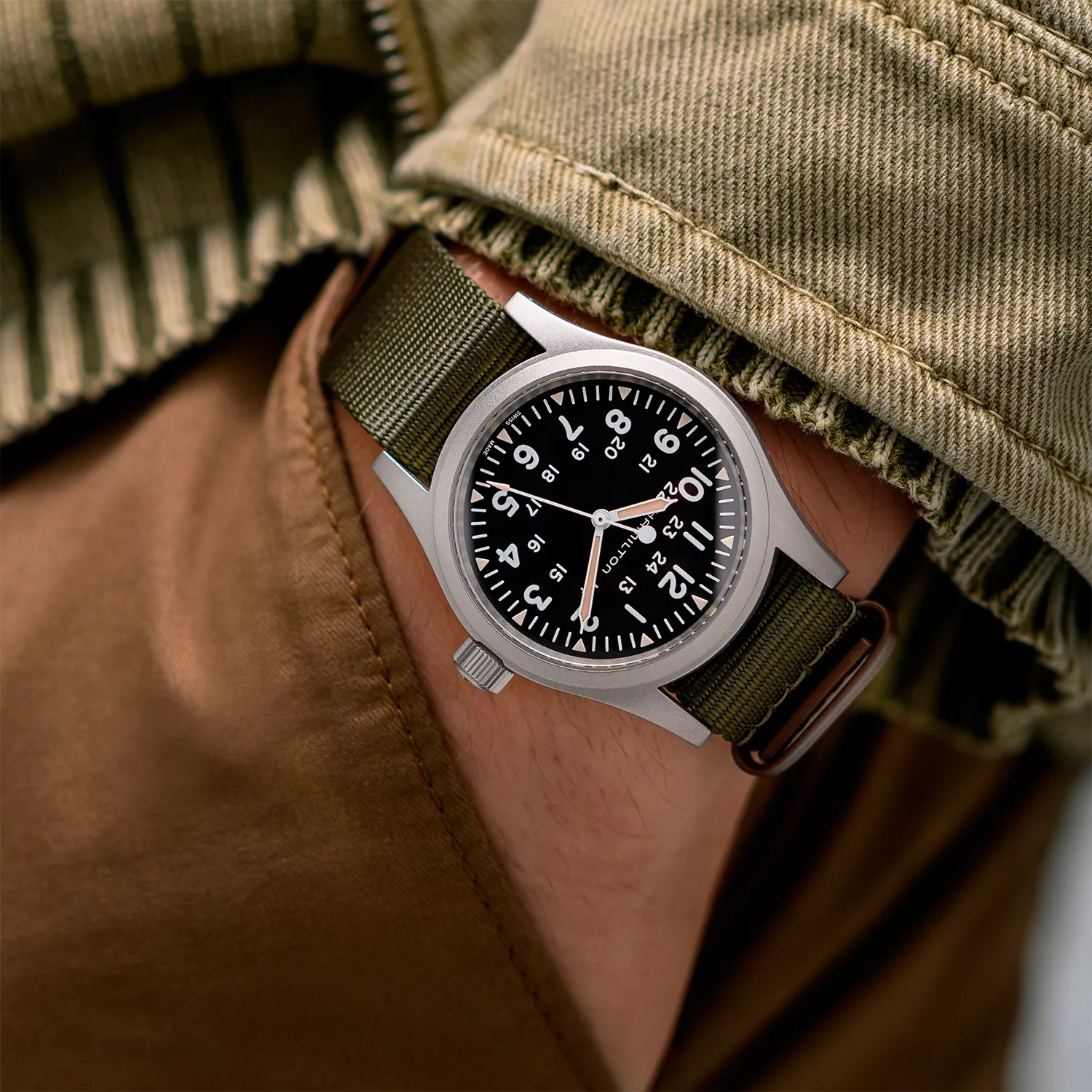Hamilton Khaki Field Mechanical H69439931 wrist shot in outdoor jacket